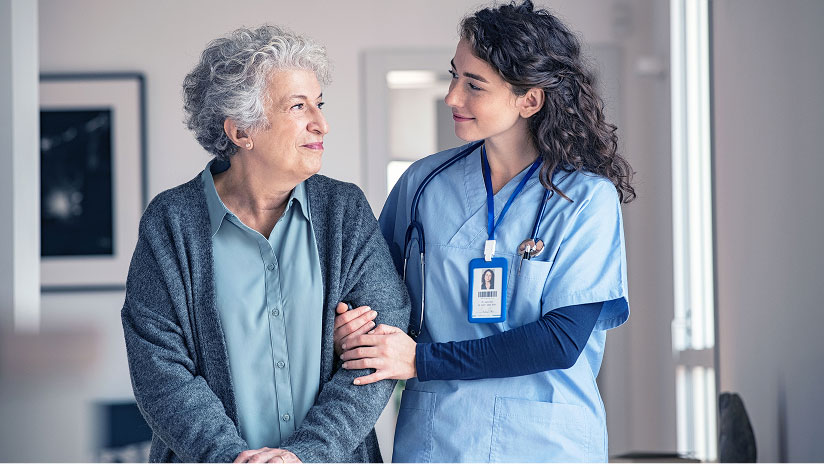 Healthcare worker walking with a patient