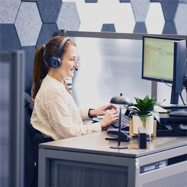 woman working at desk with a headset